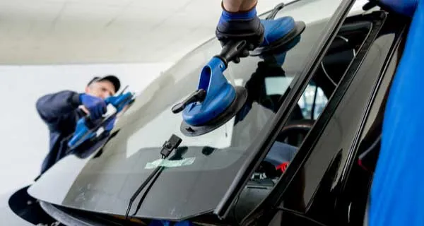 Auto glass being replaced on a vehicle