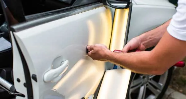 Paintless dent repair being performed on a car door